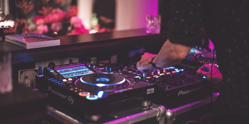 DJ performing on stage with Pioneer controller - epic music collaboration